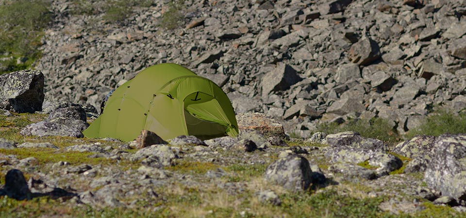 Quadratic Tent with rocks behind