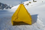 Modular shelter pitched on snow, with open sidewall.