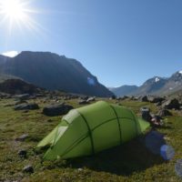 Quadratic tent pitched in the the mountains