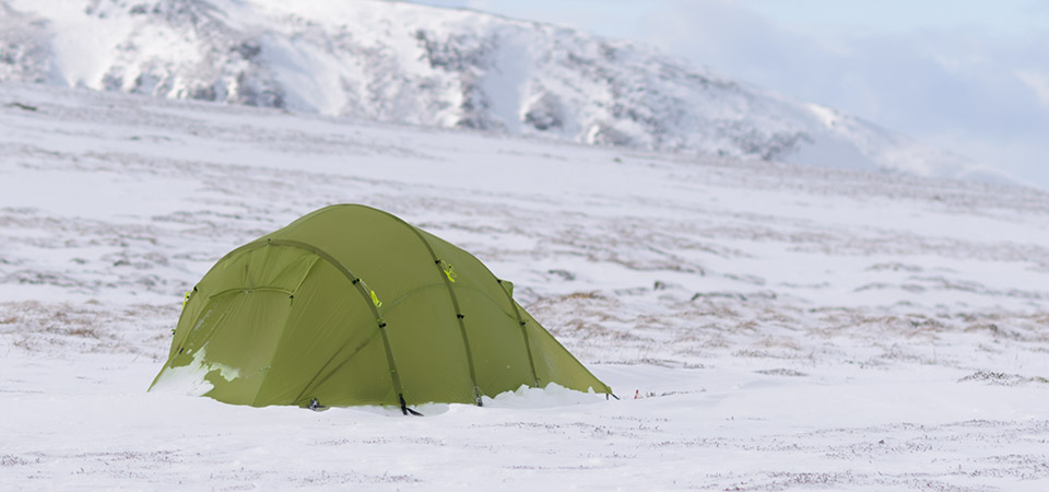 Quadratic Tent with snow ridge behind